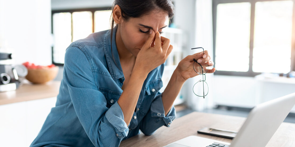 woman at desk with headache