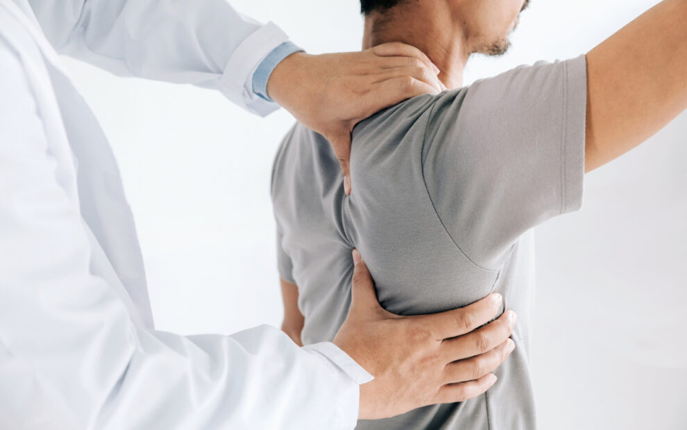 Chiropractor Performing Adjustment on Patient's Back