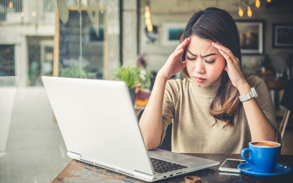 Woman with Headache Working in Front of Computer