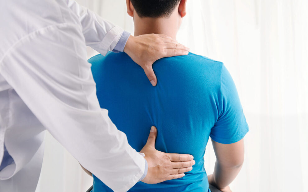 Chiropractor examining patient's spine